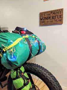Loaded fat bike next to a sign reading it's the most wonderful time of the year